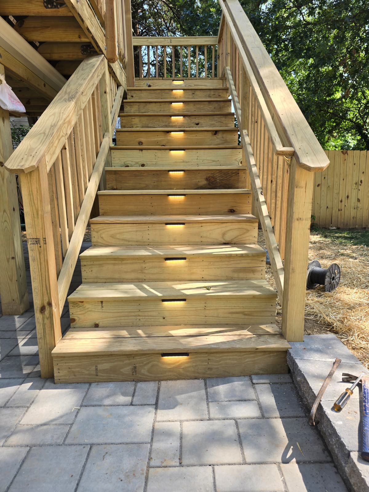 Custom wooden deck stairs with integrated step lighting