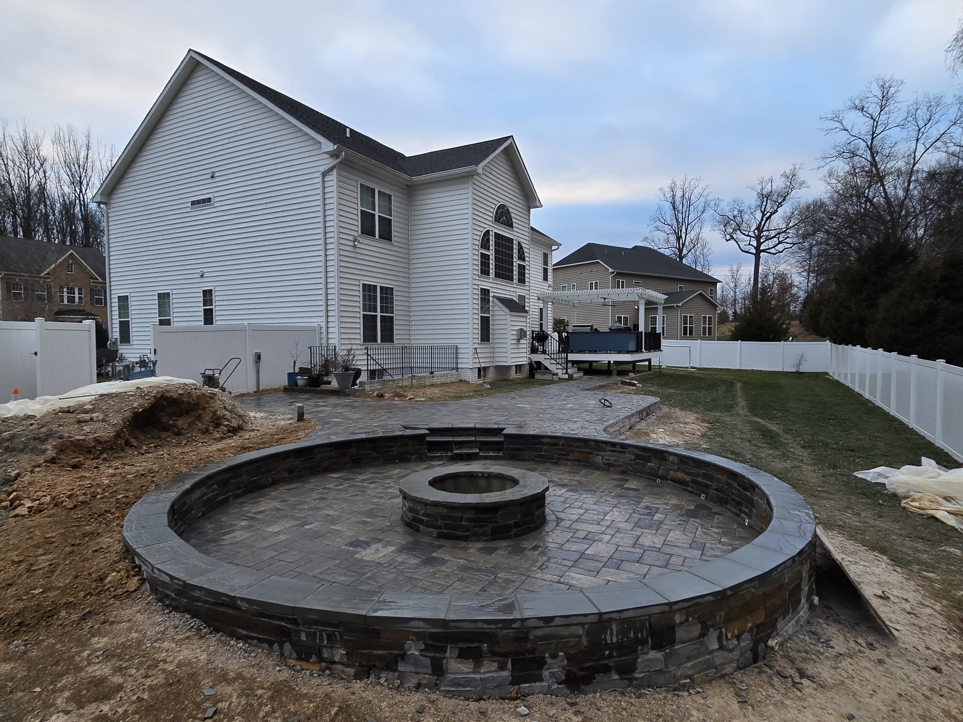 Circular stone fire pit patio under construction