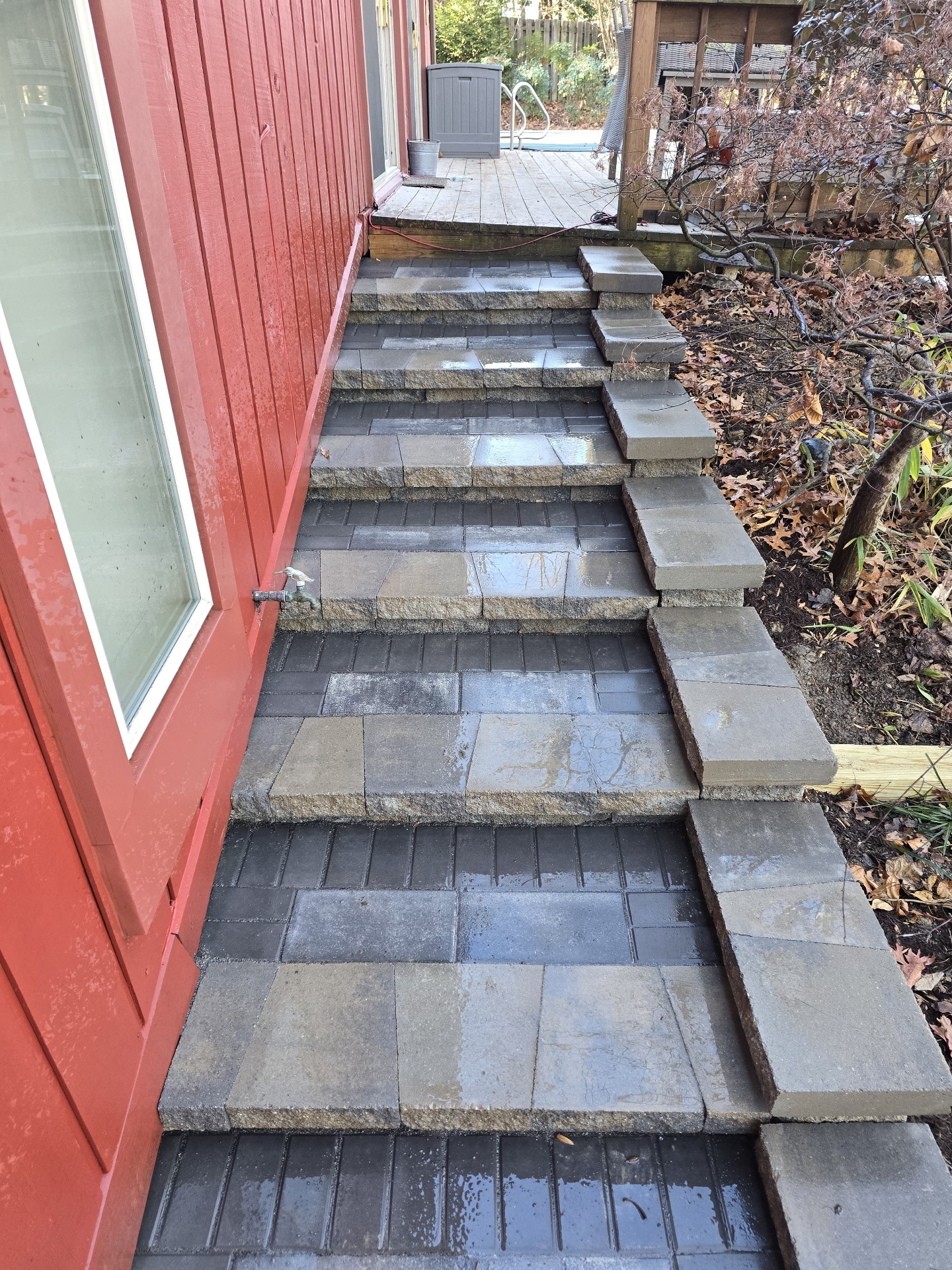 Multi-level paver steps along red garden shed