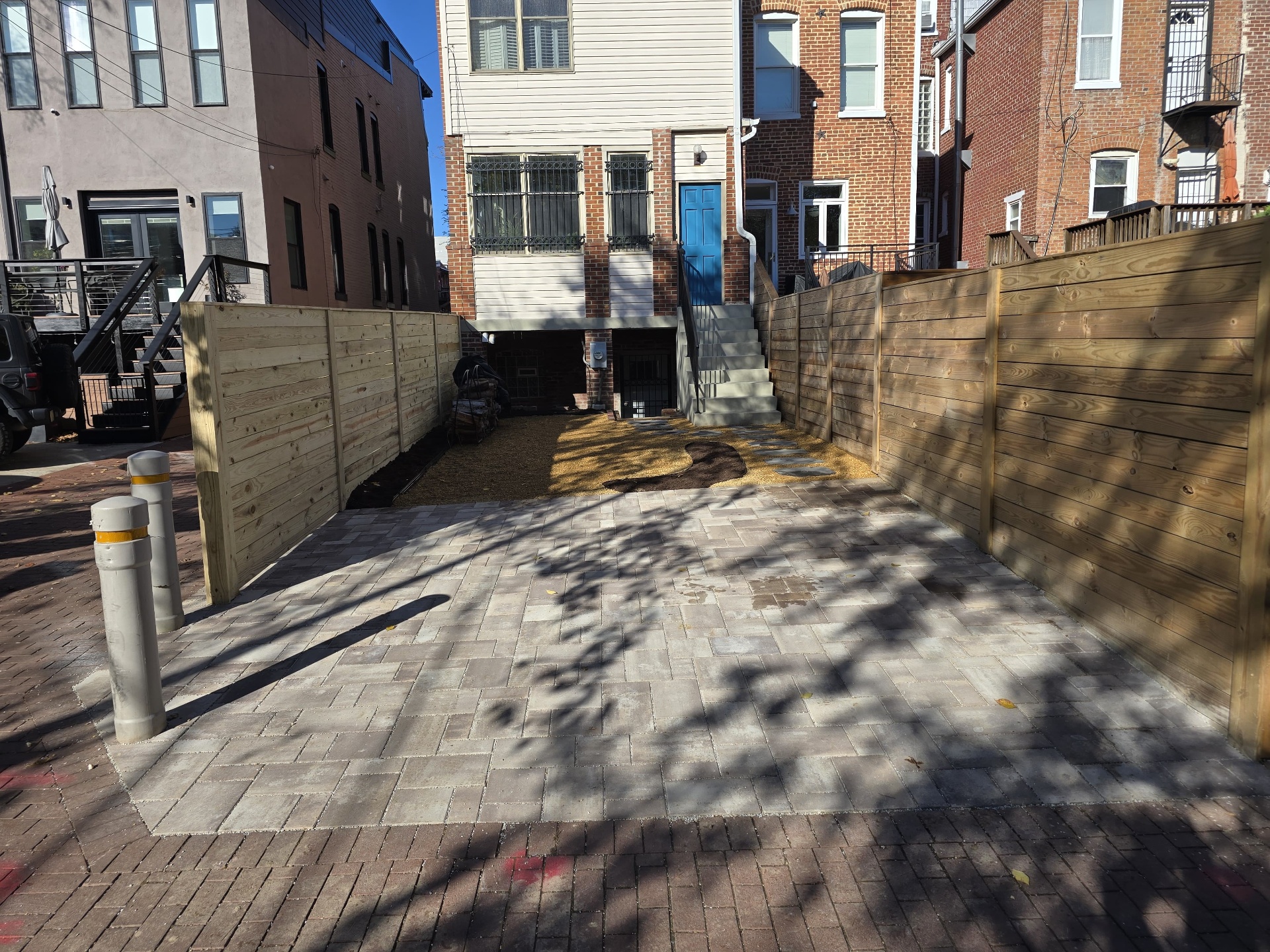 Urban paver courtyard with new wood fencing