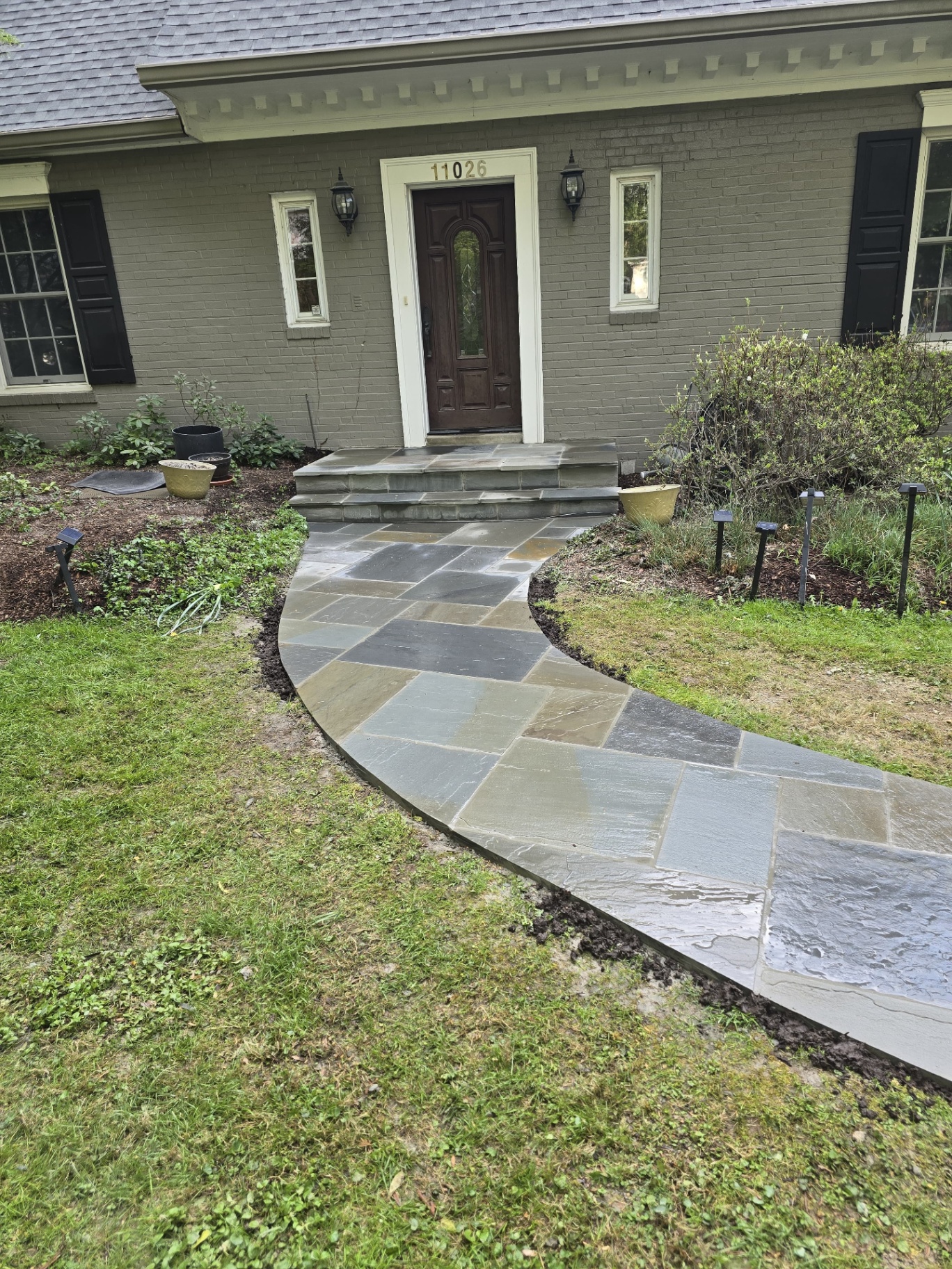 Curved bluestone front walkway leading to main entrance