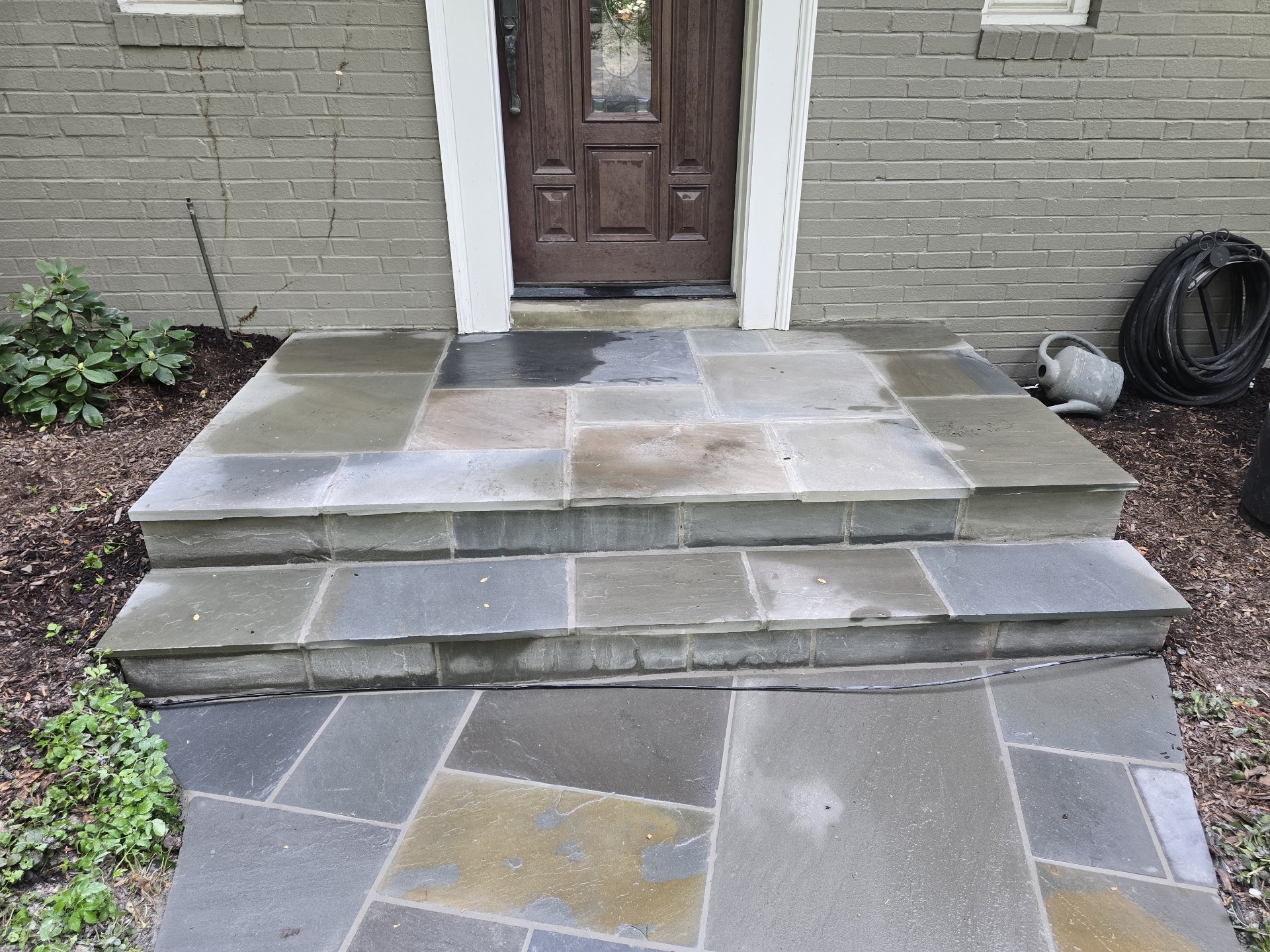 Bluestone front porch landing with wide stone steps