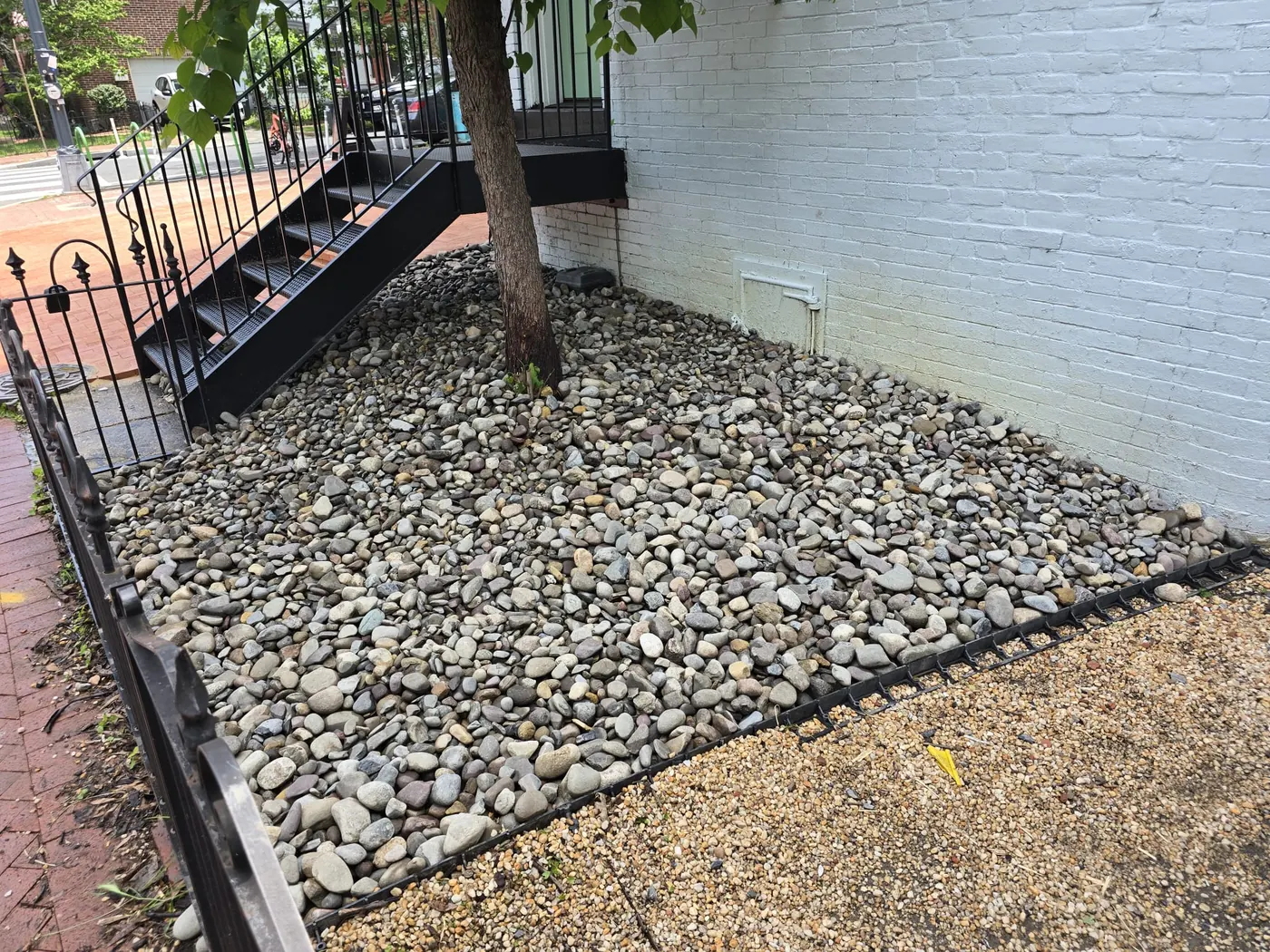 River rock landscaping bed around tree