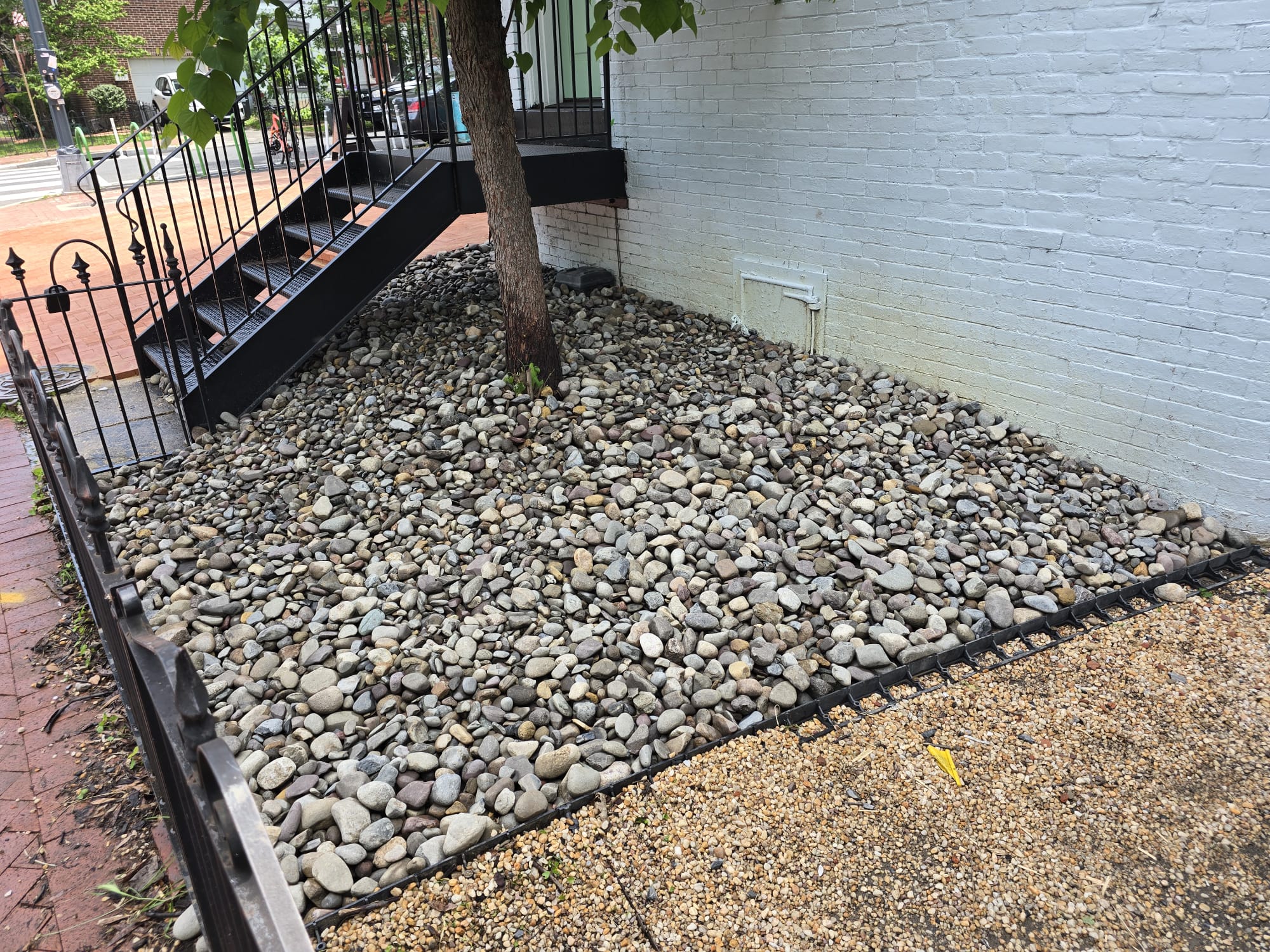 River rock landscaping bed around tree